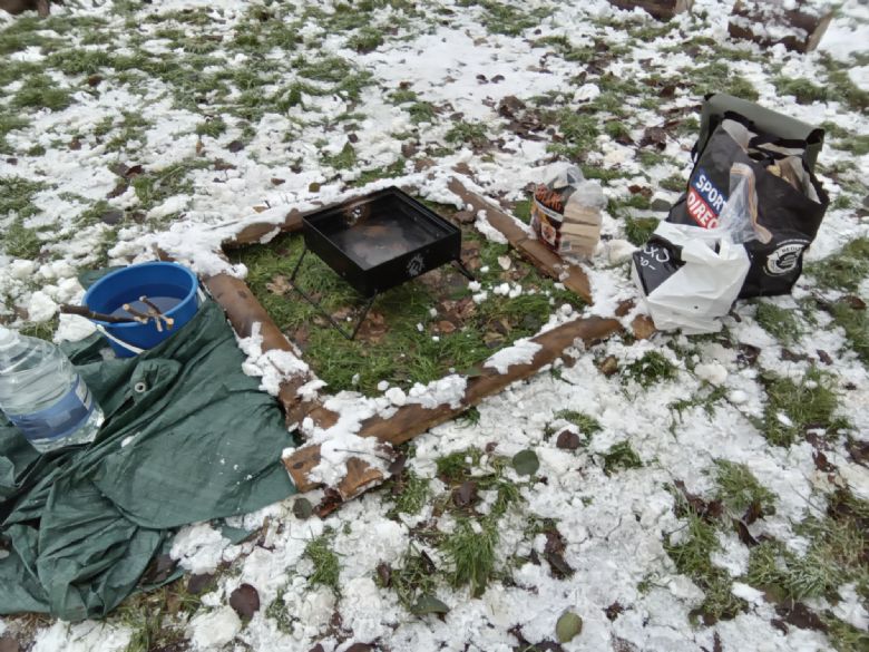 A small unlit fire pit in the snow